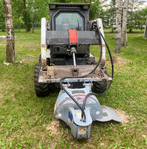 Baxter landscape crew grinding a tree stump